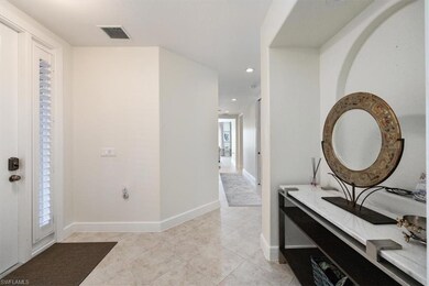 Foyer entrance with light tile patterned flooring