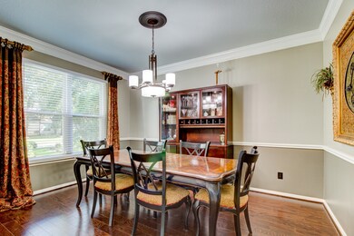 Dining room features beautiful crown molding and c