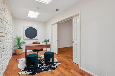 Office space featuring wood finished floors, base