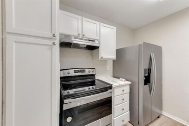 Kitchen with stainless steel appliances, white cab