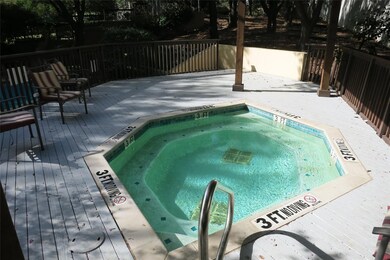 View of pool featuring a wooden deck and a communi