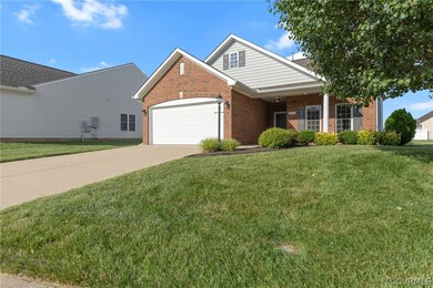 View of property featuring a garage and a front la