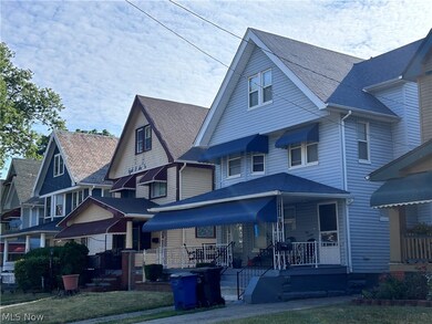 View of front facade featuring a front yard and covered porch