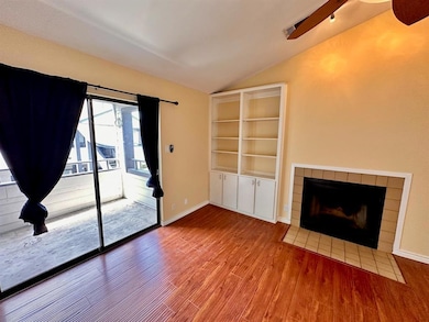 Unfurnished living room with lofted ceiling, a ti