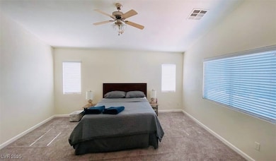Bedroom featuring carpet flooring, multiple window