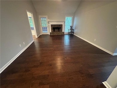 Unfurnished living room featuring vaulted ceiling,