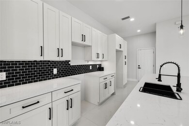 Kitchen featuring light stone counters, a sink, wh