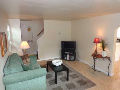Living Room. An open floor plan is equipped with low maintenance ceramic tile.
