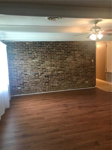 Great room has sunny window overlooking covered pa