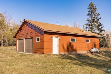 View of outbuilding with a yard and a garage