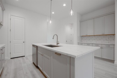 Kitchen with Pendant Lighting and Plenty of Cabine
