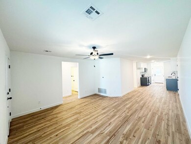 Unfurnished living room featuring baseboards, a ce