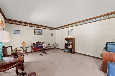 Sitting room with carpet floors and crown molding