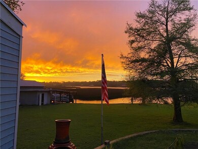 Yard at dusk featuring a water view