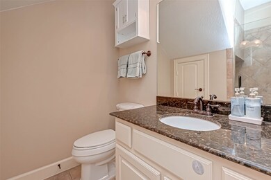 En-suite bathroom features granite countertop with