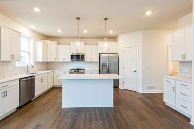 (Actual photo of the home) Soaked in natural sunlight, the homes eat- in dining room is a wonderful spot to gather.