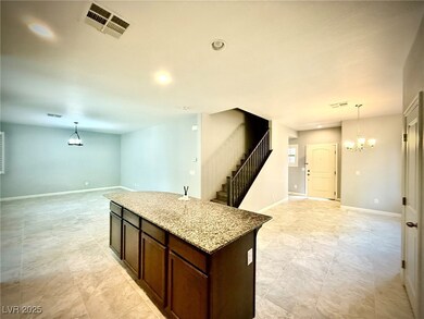 Kitchen with visible vents, baseboards, decorative