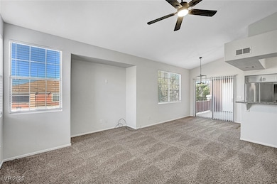 Unfurnished living room with ceiling fan, carpet f