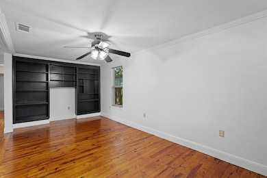 Unfurnished bedroom with hardwood / wood-style fl