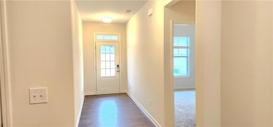 Entryway featuring a healthy amount of sunlight and dark carpet