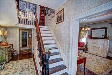 Original staircase and parlor to the right.