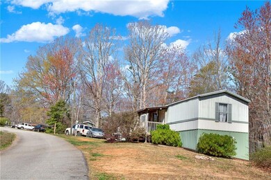 View of side of home featuring a lawn