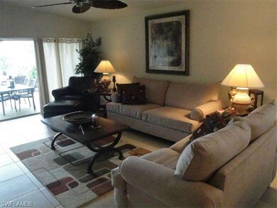 Living room with tile floors and custom ceiling fan.