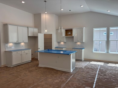 Kitchen featuring a kitchen island, decorative backsplash, pendant lighting, high vaulted ceiling, gas stainless steel appliances, quartz countertops, and a walk in pantry.