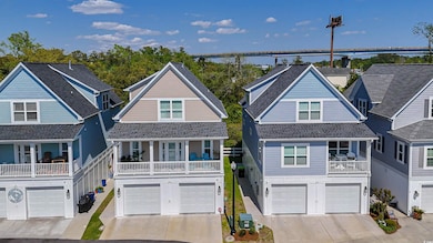 Coastal home with roof with shingles, a garage, an