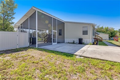Rear view of house with concrete driveway, a carpo