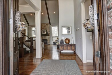 Magnificent double wood doors entry into foyer.