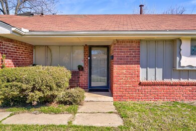 Entrance to property with brick siding, board and 