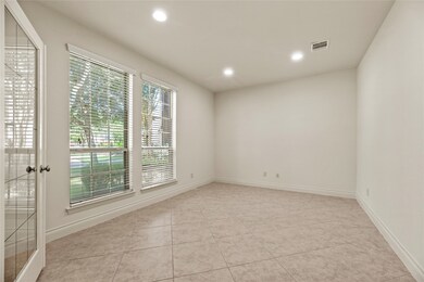 Home office with tile flooring and French doors fo