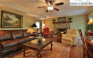 Nicely furnished living room with stone fireplace
