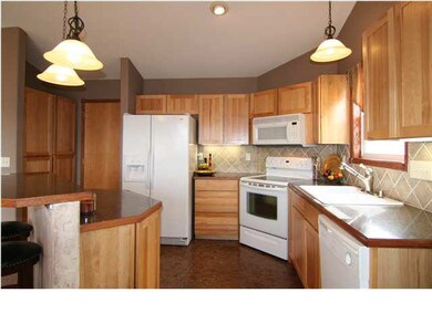 Lovely tile backsplash, pantry, island with storag