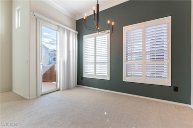 Unfurnished dining area featuring carpet floors, ornamental molding, baseboards, and a chandelier