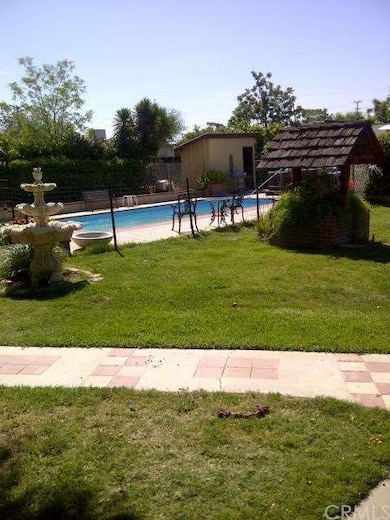 POOL IN BLARGE BACK YARD WALKING PATHS PAVED AND G