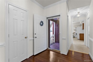 Entrance foyer with dark hardwood / wood-style flo