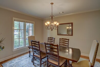 Dining area with a notable chandelier, light wood-