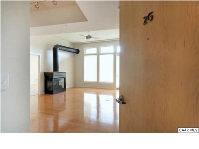 Inside, hardwood floors gleam in the light from wa