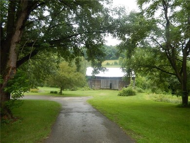 Private drive leading to large barn.