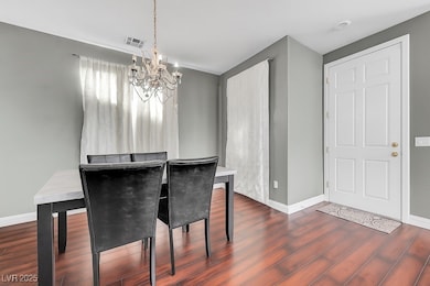 Dining space featuring a chandelier and dark wood finished floors