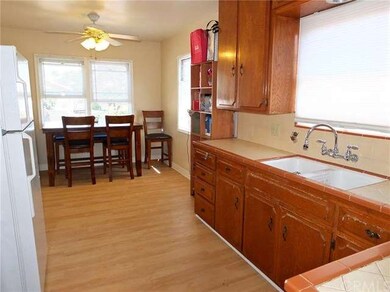 Kitchen with dining area in front of windows. 