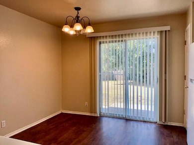 Spare room with dark wood-type flooring and a cha
