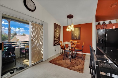 Dining area with carpet floors, a chandelier, base