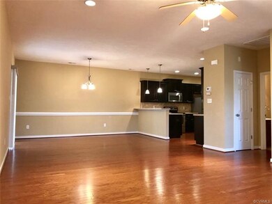 Dining area with beautiful wood floors, chair rail