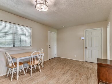 Dining room featuring a textured ceiling and light