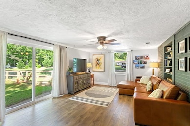 Living area with hardwood / wood-style flooring, a
