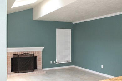 Living room has a sky light window above.