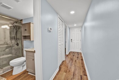 Hallway featuring light hardwood / wood-style floo